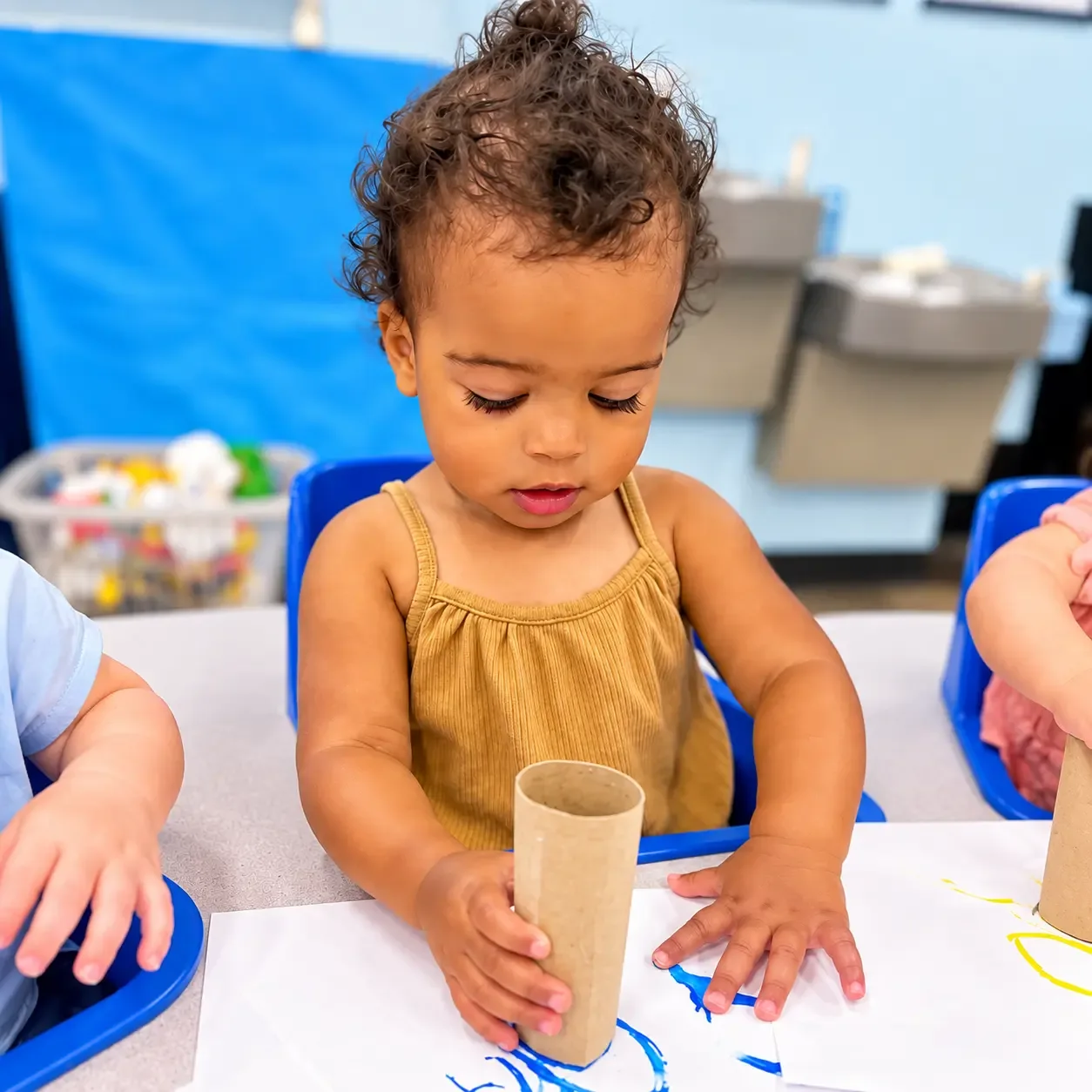 Little one painting with a cardboard tube
